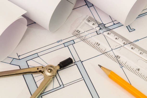istock Rolled house diagrams and accessories for drawing lying on construction drawing 1454376099