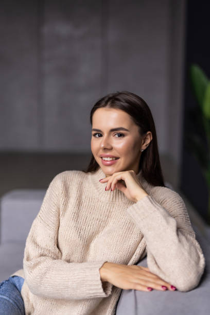 istock Happy young woman lying on couch and relaxing at home 1454377072