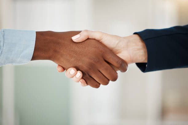 istock Handshake, welcome and business people in a partnership shaking hands after a successful negotiation for a deal. Thank you, diversity and b2b collaboration agreement after a meeting or interview 1454377396