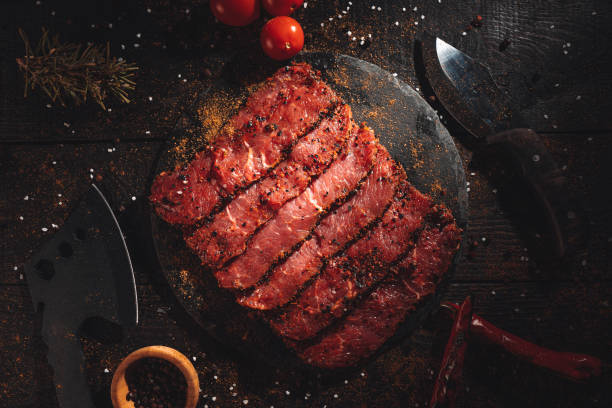 Raw beef steak fillets on dark table. stock photo