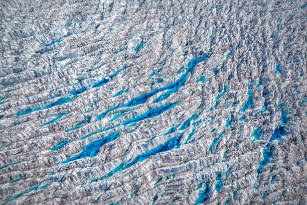 Textures, cracks, and small lakes in the icebergs surface at Jakobshavn Glacier also known as Ilulissat Glacier in Greenland