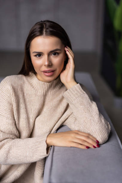 istock Happy young woman lying on couch and relaxing at home 1454378430