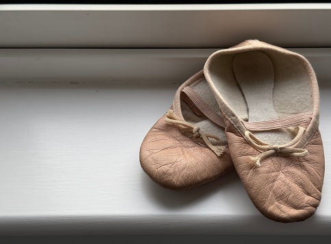 A child’s used and much loved ballet shoes.
