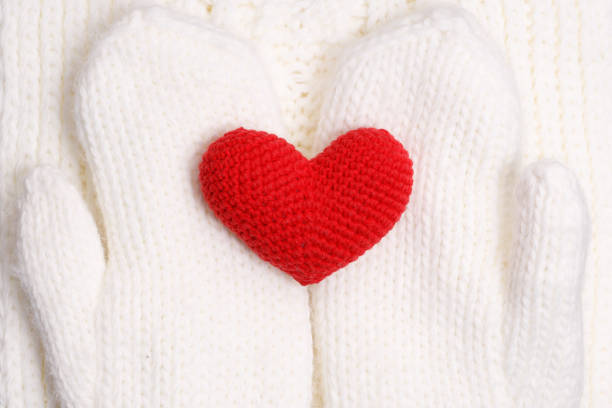 istock red knitted heart on white knitted harnesses 1454378806