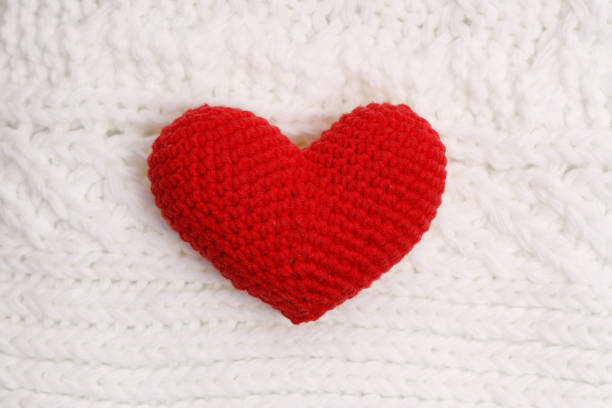 istock red knitted heart on a white woolen scarf 1454378848