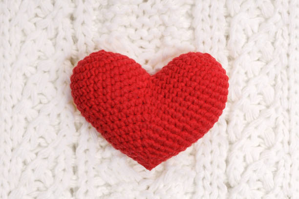 istock red knitted heart on a white woolen scarf 1454378889