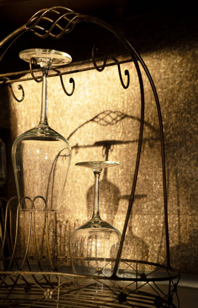 wine glasses and their shades on a shiny brawn wall