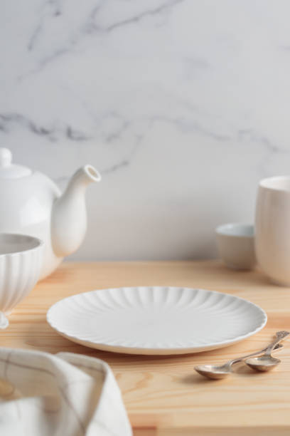 istock Empty tableware - white plate, a bowl and a cup on wooden table as a background for a dish foodbackground 1454382675
