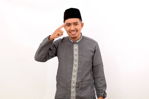 istock Smart asian muslim man standing while pointing his head to thinking something. Isolated on white background 1454383088
