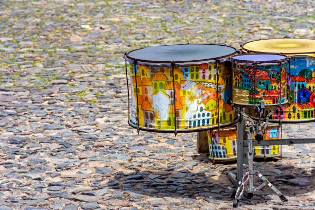 Ethnic drums decorated with paintings on the cobblestones of the Pelourinho slopes in Salvador, Bahia