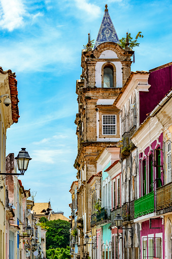 Baroque church tower emerging from among the old houses in the historic neighborhood of Pelourinho in Salvador, Bahia