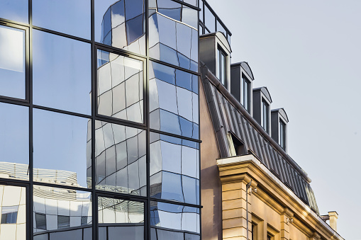 modern glass facade beside an old building in the center of Lille, France