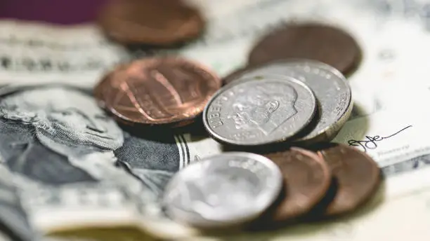 Photo of United States dollars and coins in macro photography. Economy and finance.