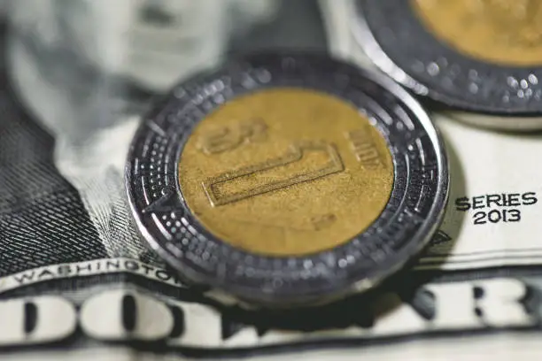 Photo of Mexico coins and US dollar banknotes in macro photo. Economy and finance.