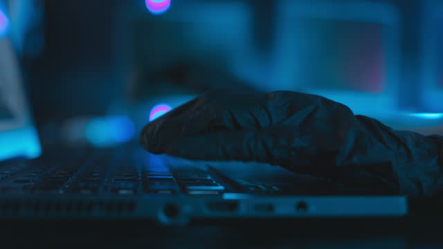 Close up hand of Women hacker With a mask executing digital espionage