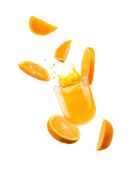 Orange juice Glass of orange juice with splash and orange slices falling, isolated on white. orange juice stock pictures, royalty-free photos & images