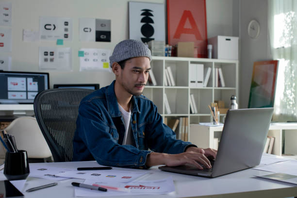 Asian man Graphic designer working in office.