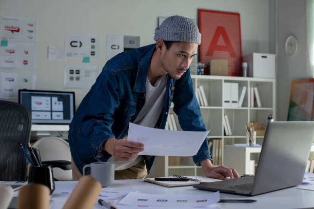 istock Asian man Graphic designer working in office. 1454390790