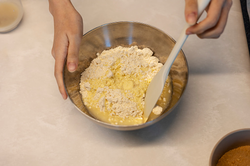 Making hotteok dough before baking, whip and mixture into a paste by hands