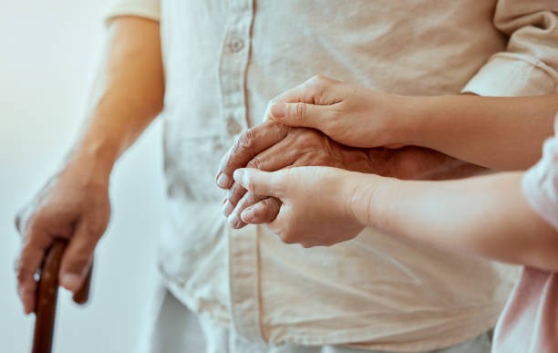 senior, child and hands holding together to show family love, trust and support to help grandparent. elderly man with a helping young kid showing kindness, community and hope for retirement - ouderenzorg stockfoto's en -beelden