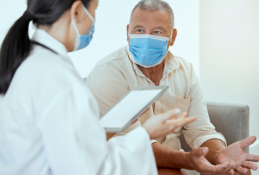 Covid, senior patient and doctor with tablet, discussion for medical results and appointment in hospital. Mockup, medical professional or man with mask talk, conversation or telehealth for healthcare