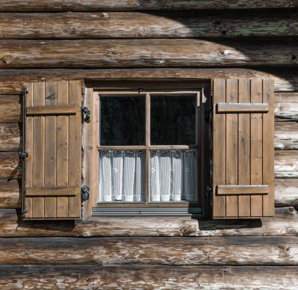 istock windows with shutters in textured wooden wall 1454394137