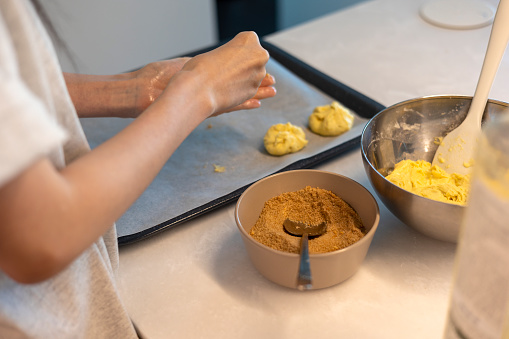 Making hotteok with sugar before baking, shape dough into a ball by hands