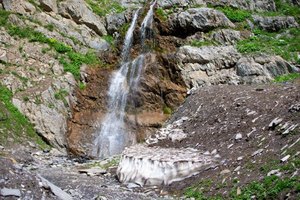 Beautiful waterfall in the mountains. Water flows down from the mountains.