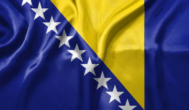 Bosnia and Herzegovina flag wave close up. Full page Bosnia and Herzegovina flying flag. Highly detailed realistic 3D rendering.