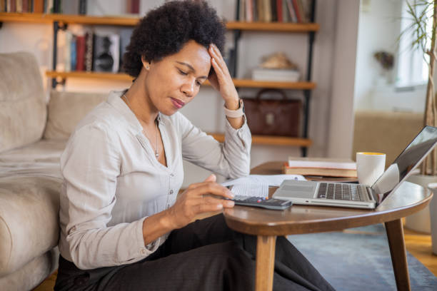 istock Mid adualt woman going through paperwork 1454396959