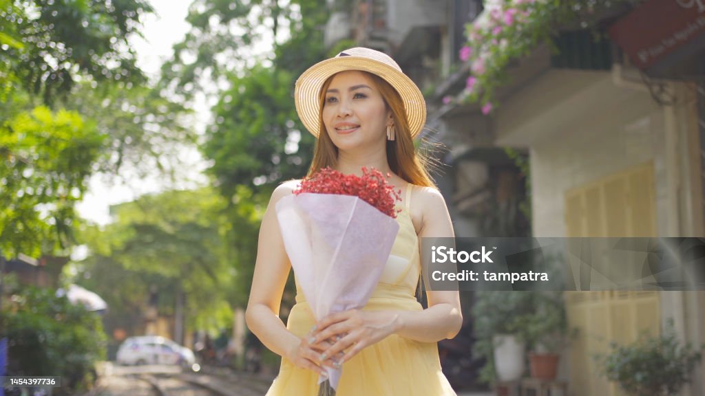 Portrait of Asian Vietnamese woman girl with train railway traveling in Hanoi urban city town, Vietnam. People lifestyle. 40-44 Years Stock Photo
