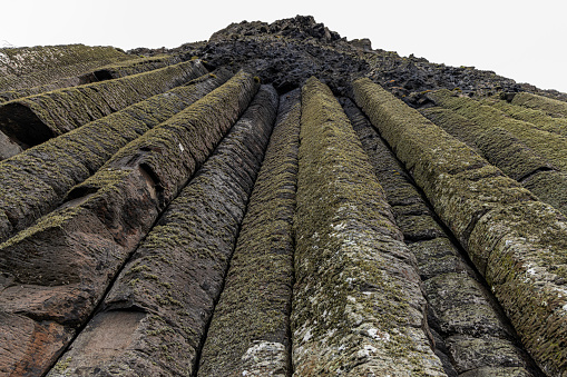 These 60 rock formation is called the Giantaas Organ Pipes. They are about 40 feet tall. It is part of the Giants Causeway in Northern Ireland.
