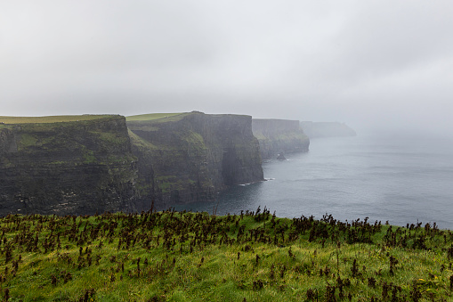 The Cliffs of Moher are sea cliffs located at the southwestern edge of the Burren region in County Clare, Ireland. They run for about 14 kilometres