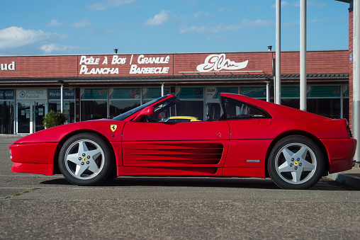 Lutterbach - France - 4 September 2022 - Profile view of red ferrari 348 parked in the street