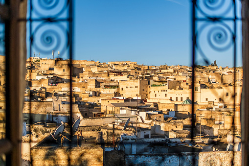 Fez medina seen through riad's window with decorative grate, Morocco, North Africa