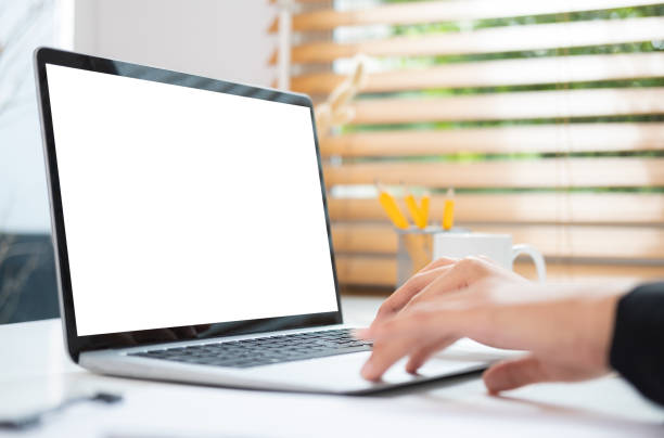 istock Close up view of man hands typing on laptop computer. Empty screen for your advertise text. 1454401917