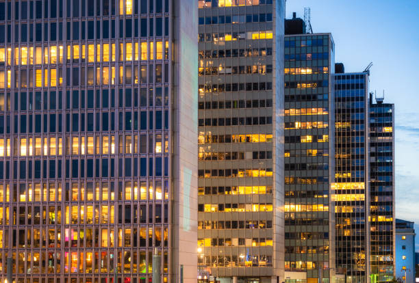 Offices illuminated at dusk in a series of office towers in downtown Stockholm, arranged in a row.