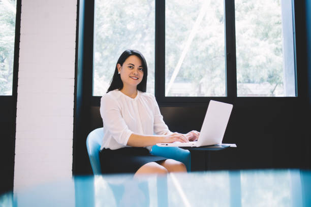 istock Confident businesswoman using laptop and working remotely 1454406484