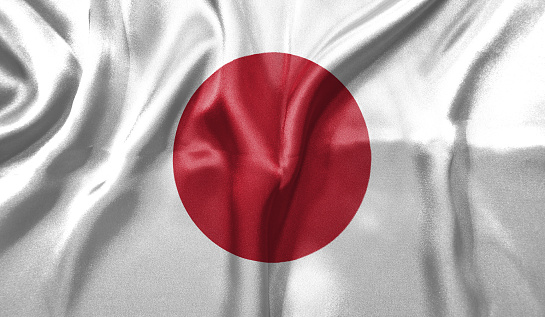 Japan flag wave close up. Full page Japan flying flag. Highly detailed realistic 3D rendering.