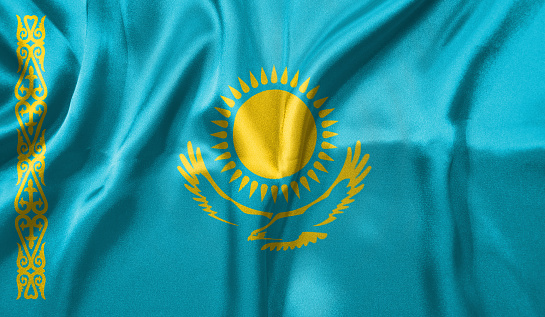 Kazakhstan flag wave close up. Full page Kazakhstan flying flag. Highly detailed realistic 3D rendering.