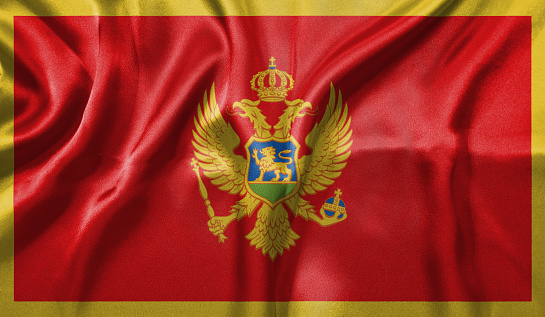 Montenegro flag wave close up. Full page Montenegro flying flag. Highly detailed realistic 3D rendering.