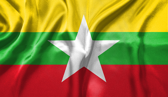 Myanmar flag wave close up. Full page Myanmar flying flag. Highly detailed realistic 3D rendering.