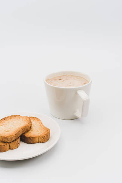 istock delicious hot vegan Cappuccino with foam in a white cup with crispy biscuits on a white tabletop 1454409724