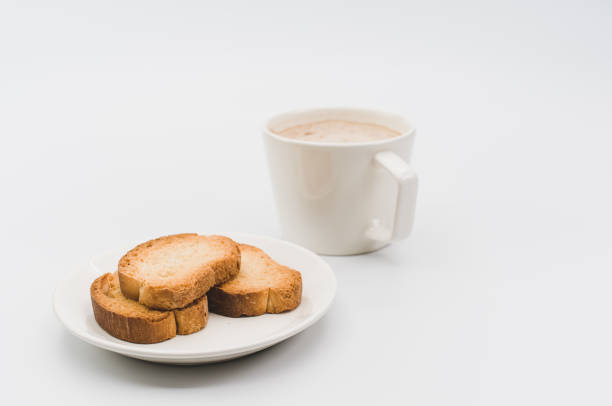 istock delicious hot vegan Cappuccino with foam in a white cup with crispy biscuits on a white tabletop 1454409728