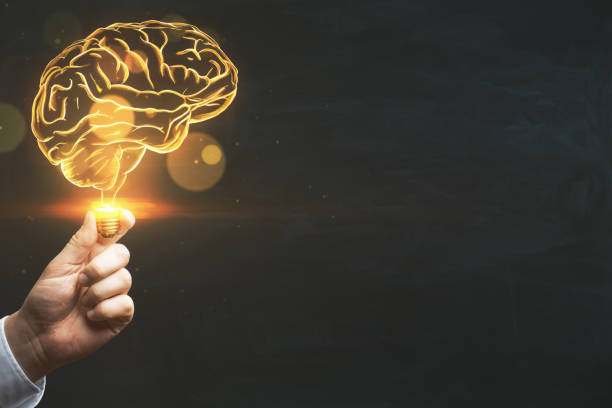 istock Brainstorm, creative idea and business success concept with digital glowing yellow human brain in man hand on abstract dark blank background with space for your advertising campaign or poster, mock up 1454410285