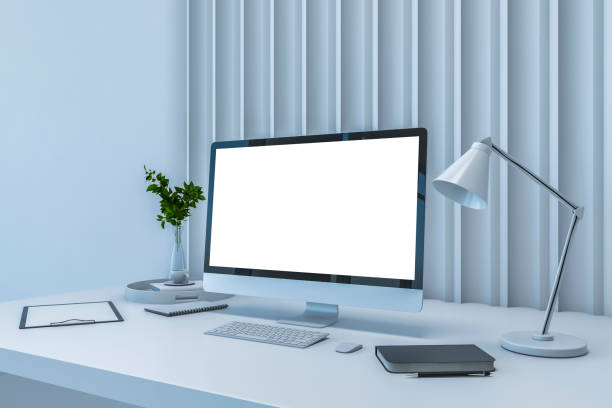 istock Perspective view on blank white modern computer screen with space for your logo on white workspace table with stylish lamp, notebook and green plant on slatted wall background. 3D rendering, mock up 1454410319