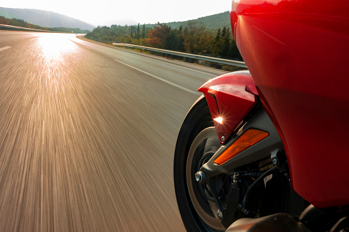 motorcycle wheel speeding on asphalt