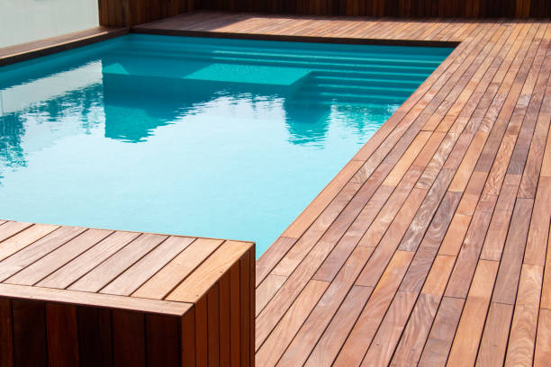 istock Hardwood ipe pool deck on direct sun heat, summer swimming pool decking design idea 1454411241