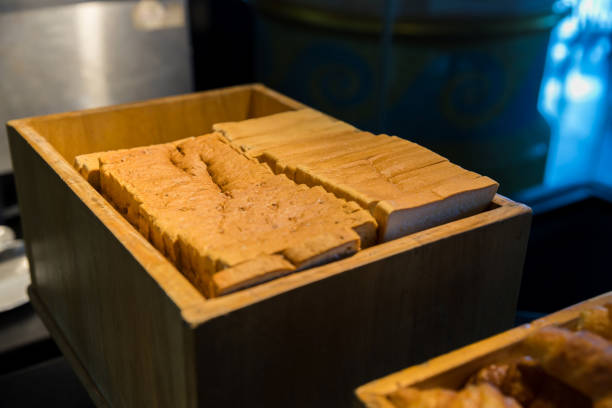 istock Assortment of fresh bread on table in buffet. Sliced white bread 1454412042