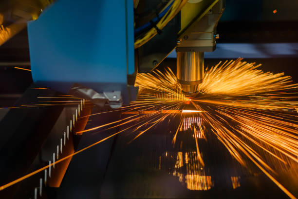 istock CNC laser cutting machine working with sheet metal with sparks 1454412746